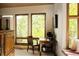 Bright home office space with large windows and a wooden desk overlooking lush greenery at 8932 Eastridge Rd, Golden, CO 80403