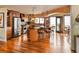 Open kitchen featuring stainless appliances, wood cabinets, granite countertops, and bar seating at 8932 Eastridge Rd, Golden, CO 80403
