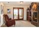 Inviting living room with fireplace and bookcase, bathed in natural light with scenic outdoor views at 8932 Eastridge Rd, Golden, CO 80403