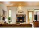 Cozy living room featuring a stone fireplace, wood accents, and access to an outdoor balcony at 8932 Eastridge Rd, Golden, CO 80403