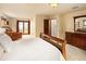 Spacious main bedroom with dresser, accent chair, and private balcony offering a relaxing retreat at 8932 Eastridge Rd, Golden, CO 80403