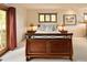 Comfortable main bedroom featuring a wood bed frame, bedside tables, and balcony access at 8932 Eastridge Rd, Golden, CO 80403