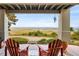 A covered patio providing panoramic landscape views, furnished with Adirondack chairs and decor at 8932 Eastridge Rd, Golden, CO 80403