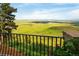 Breathtaking panoramic view from the balcony showcasing rolling green hills and a distant cityscape at 8932 Eastridge Rd, Golden, CO 80403
