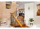 Unique staircase features custom iron railing, hardwood treads, and views into the dining area at 8932 Eastridge Rd, Golden, CO 80403