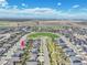 Aerial view of the property, showing its position in a neighborhood near a central park, with ample community space at 27853 E 8Th Ave, Aurora, CO 80018