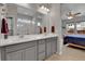 Bright bathroom with double sinks, modern fixtures, glass-enclosed shower, and seamless bedroom access at 27853 E 8Th Ave, Aurora, CO 80018