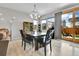 Bright dining room with a wooden table and chairs, next to sliding glass doors to the backyard at 27853 E 8Th Ave, Aurora, CO 80018