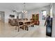 Open-concept dining area with wooden furniture, seamlessly blending with living space at 27853 E 8Th Ave, Aurora, CO 80018