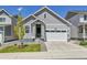 Charming home featuring a two-car garage, well-manicured lawn, and an inviting covered front porch at 27853 E 8Th Ave, Aurora, CO 80018