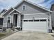 Charming gray home showcasing a two-car garage and a welcoming covered front porch at 27853 E 8Th Ave, Aurora, CO 80018