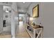 Inviting hallway with light hardwood floors, stylish decor, and a glimpse into the living spaces at 27853 E 8Th Ave, Aurora, CO 80018