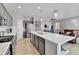 Open-concept kitchen with a large island and stainless steel appliances at 27853 E 8Th Ave, Aurora, CO 80018