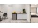 A basement bar area that includes a wood countertop, white cabinets, mini fridge and stainless steel sink at 6894 E 133Rd Pl, Thornton, CO 80602