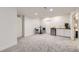 Spacious finished basement with gray carpet, neutral walls, bar area, and access to other rooms at 6894 E 133Rd Pl, Thornton, CO 80602