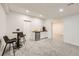 Finished basement with a bar, mini fridge, and stools for comfortable entertaining at 6894 E 133Rd Pl, Thornton, CO 80602