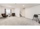 Finished basement area with a comfortable seating area, modern light fixtures and neutral carpet at 6894 E 133Rd Pl, Thornton, CO 80602