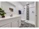 Modern bathroom with a white vanity, decorative black and white tile, and glass shower at 6894 E 133Rd Pl, Thornton, CO 80602