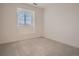Bright bedroom featuring a window with blinds and neutral carpeting, offering a clean and airy space at 6894 E 133Rd Pl, Thornton, CO 80602