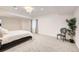 Bedroom with large windows, soft carpeting, and a comfortable chair for quiet relaxation at 6894 E 133Rd Pl, Thornton, CO 80602