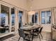 A naturally lit dining room features modern furnishings and outdoor views at 6894 E 133Rd Pl, Thornton, CO 80602