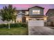 Charming two-story home with a well-manicured lawn and a large two-car garage at 6894 E 133Rd Pl, Thornton, CO 80602
