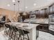 Well-appointed kitchen with an island, bar stool seating, and stainless steel appliances at 6894 E 133Rd Pl, Thornton, CO 80602