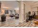 Open-concept living space showcasing wood floors, office space, and abundant natural light at 6894 E 133Rd Pl, Thornton, CO 80602
