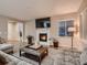 Inviting living room with fireplace, large windows, stylish decor and comfortable seating at 6894 E 133Rd Pl, Thornton, CO 80602