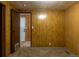 Wood-paneled bedroom with neutral carpeting, showing the open doorway at 2115 W 90Th Ave, Federal Heights, CO 80260