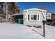 Single-story home with light blue siding, a carport, and a snow-covered yard at 2115 W 90Th Ave, Federal Heights, CO 80260