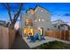 Backyard patio featuring Adirondack chairs and firepit, with view of modern 3 story home at 3928 N Vrain St, Denver, CO 80212