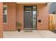 Front door of the house is brick with a keypad and potted plant and welcome mat at 3928 N Vrain St, Denver, CO 80212