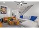 Stylish living room featuring modern furniture, a unique wooden coffee table, and staircase at 3928 N Vrain St, Denver, CO 80212