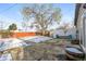 This backyard features a mature shade tree, patio area, and partially fenced yard at 1125 Newark St, Aurora, CO 80010