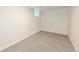 A finished basement room with gray carpet and white walls provides extra living space at 1125 Newark St, Aurora, CO 80010