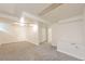 A finished basement room with gray carpet and white walls provides extra living space at 1125 Newark St, Aurora, CO 80010