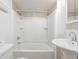 This bathroom features a shower and tub combination, a pedestal sink, and neutral walls at 1125 Newark St, Aurora, CO 80010