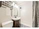Bathroom featuring a stylish vanity, bathtub, and modern fixtures at 1125 Newark St, Aurora, CO 80010