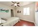 This bedroom features a ceiling fan, neutral walls, and wood floors at 1125 Newark St, Aurora, CO 80010