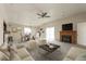 Spacious living room with vaulted ceiling, fireplace, and a view to the patio and backyard at 1125 Newark St, Aurora, CO 80010