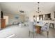 Bright open-concept living area showcases a modern kitchen, adjacent dining, and a large comfy seating area at 1125 Newark St, Aurora, CO 80010