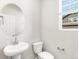 Bathroom with pedestal sink, modern fixtures, and a window providing natural light at 259 E 4Th St, Berthoud, CO 80513
