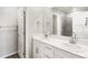 Bright bathroom with double sink vanity, large mirror, and white cabinets at 259 E 4Th St, Berthoud, CO 80513