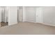 A spacious bedroom with neutral carpet, multiple doorways, and great natural light at 259 E 4Th St, Berthoud, CO 80513