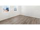 Bright, empty bedroom with hardwood floors and natural light, showcasing a blank canvas for customization at 259 E 4Th St, Berthoud, CO 80513