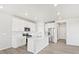 Open-concept kitchen with stainless steel appliances, white cabinets, and a center island with a sink at 259 E 4Th St, Berthoud, CO 80513