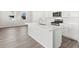 A kitchen with stainless steel appliances, white cabinets, and a large center island with a sink at 259 E 4Th St, Berthoud, CO 80513