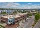 A lively commercial area surrounded by townhomes, ample parking, and walkable spaces on a partly cloudy day at 1813 W 67Th Ave, Denver, CO 80221