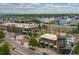 A vibrant community with modern townhomes, green spaces, and commercial buildings under a partly cloudy sky at 1813 W 67Th Ave, Denver, CO 80221